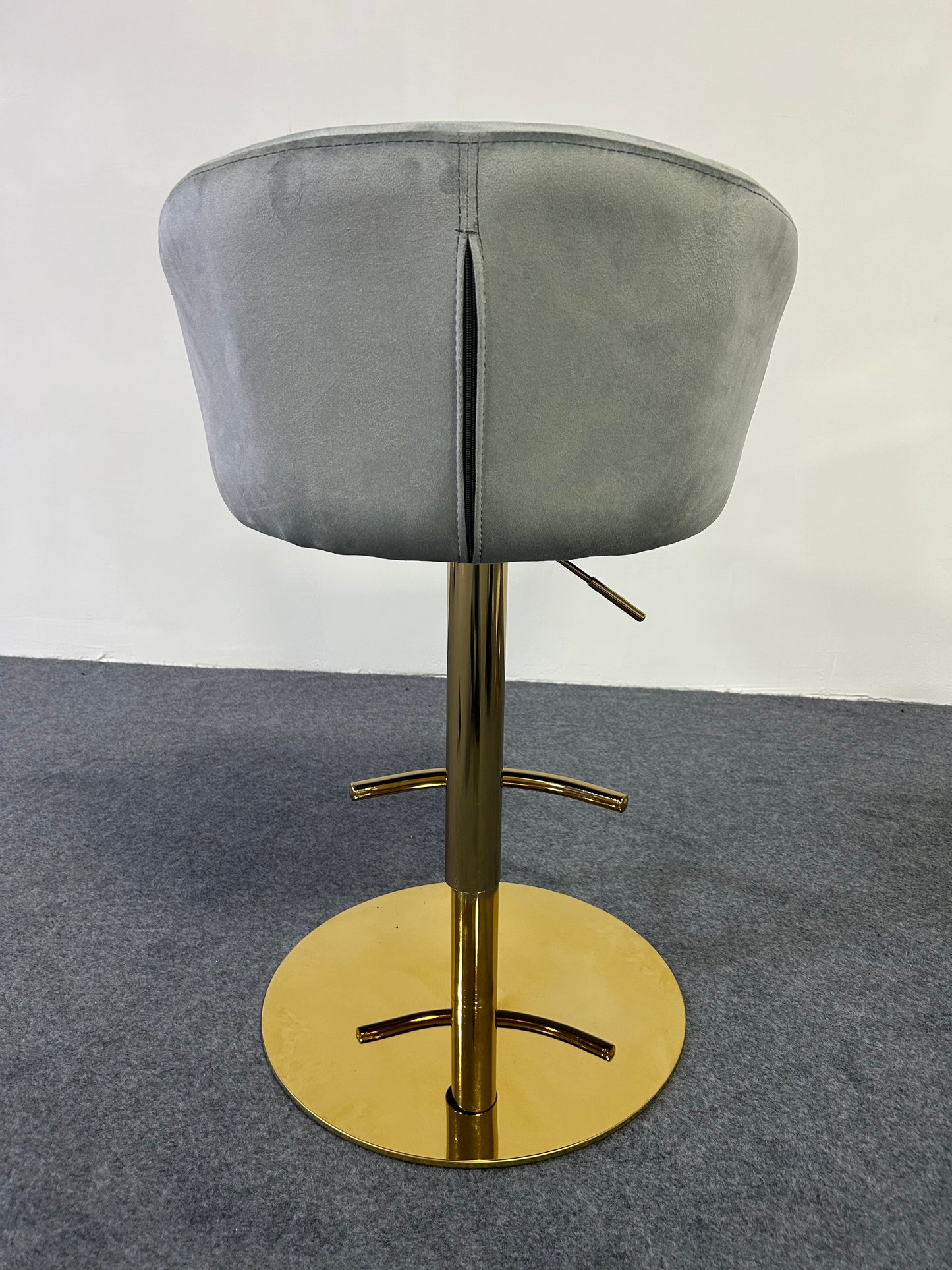 Modern Golden Barstool with gray upholstery and shiny gold base, perfect for contemporary interiors.