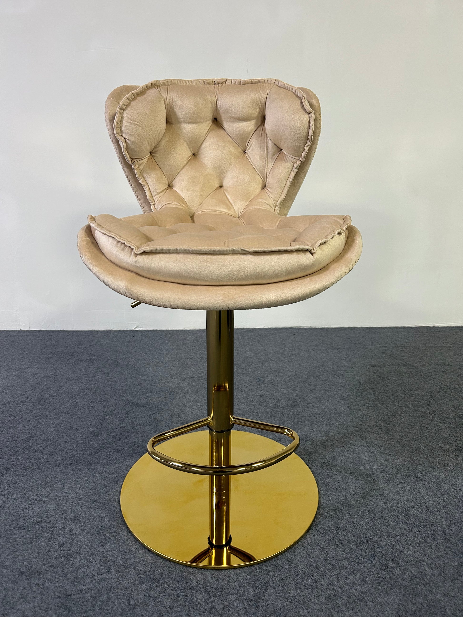 Luxury Golden Barstool with tufted beige upholstery and gold base, ideal for elegant home decor.