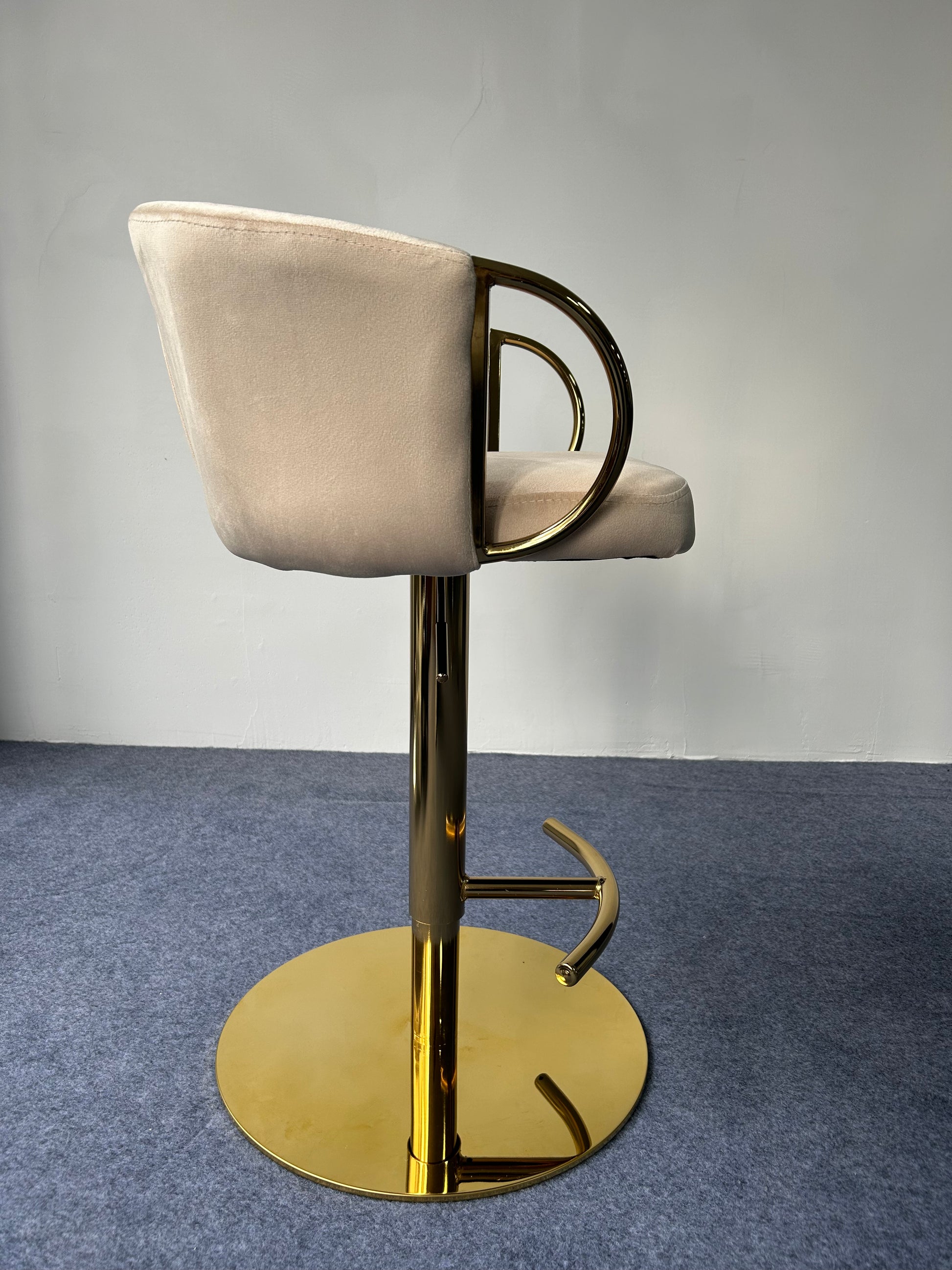 Modern Golden Barstool in a sleek design with a soft seat and shiny gold base.