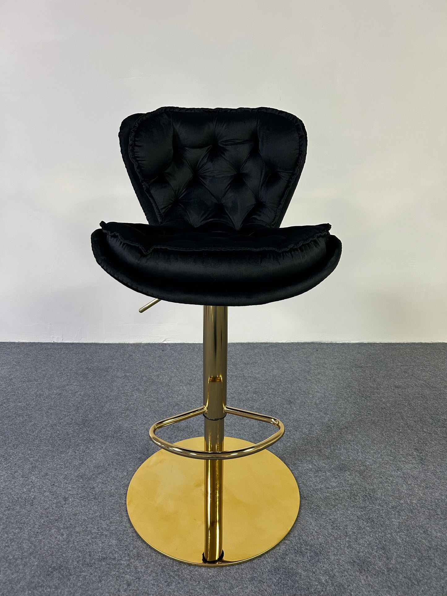 Luxury Golden Barstool featuring a sleek black tufted seat and a golden pedestal base, perfect for modern decor.