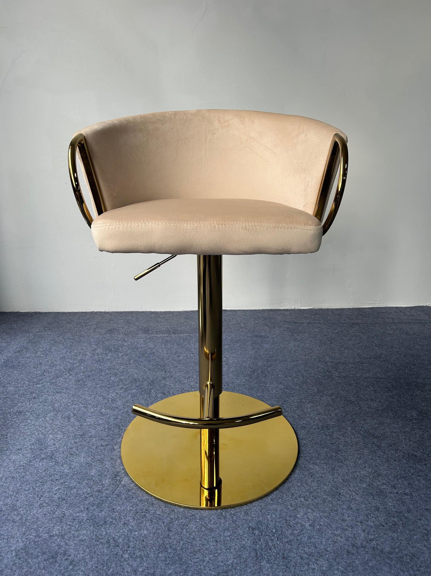 Modern Golden Barstool featuring a soft beige seat and shiny gold base, ideal for contemporary decor.