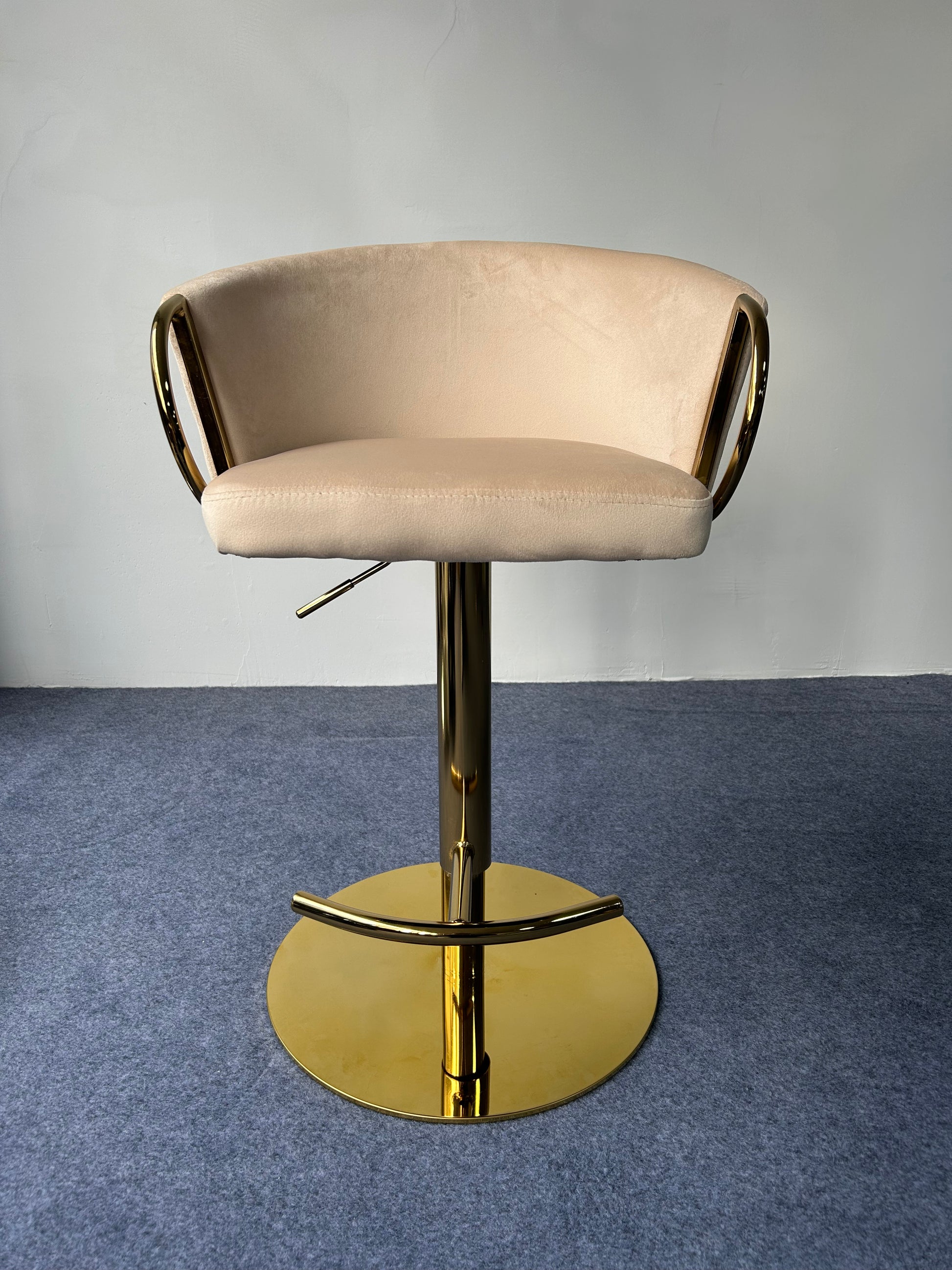 Modern Golden Barstool featuring a soft beige seat and shiny gold base, ideal for contemporary decor.