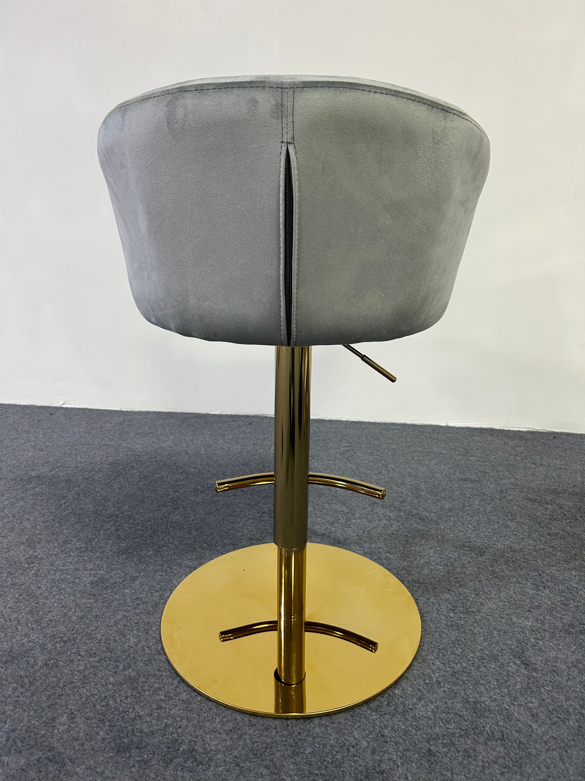 Modern Golden Barstool with gray upholstery and shiny gold base, perfect for contemporary interiors.